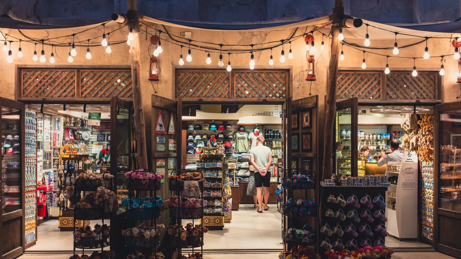A lit souvenir shop front in a Dubai souk at night.