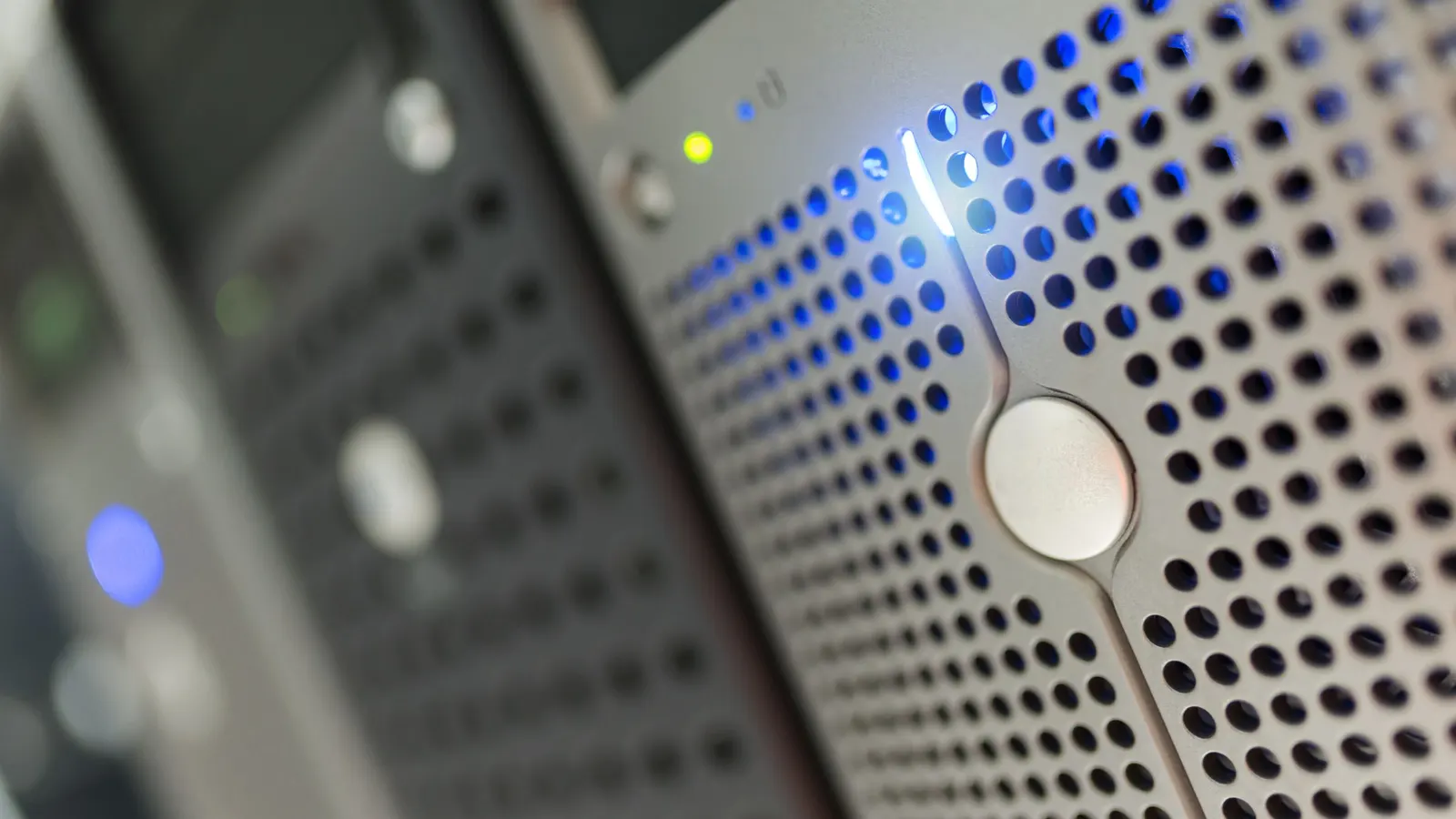 Close-up of a server rack with blue status lights in a data centre.